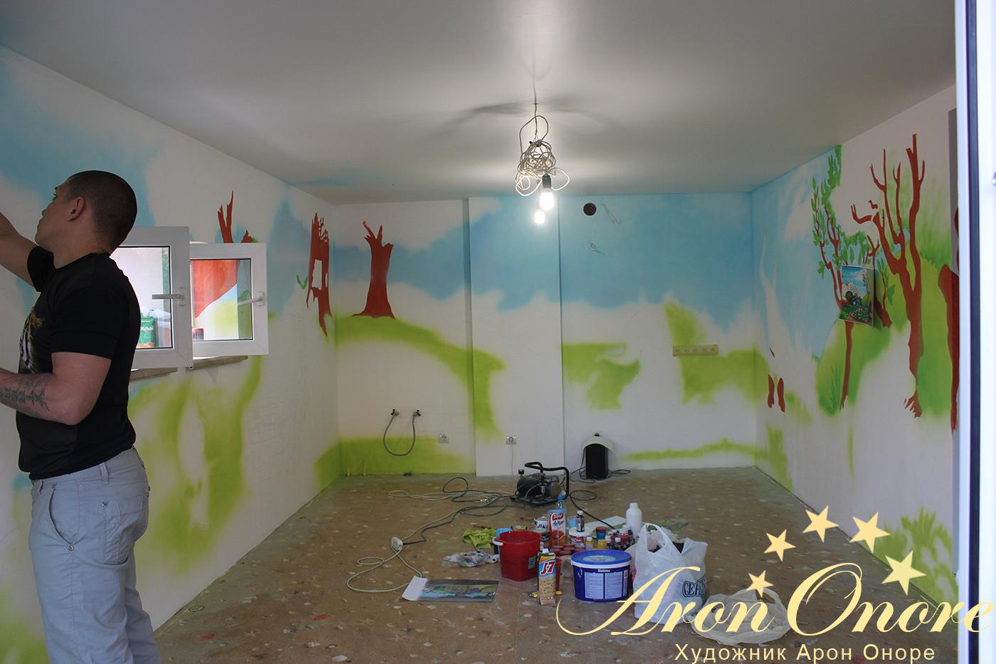 Художник арон оноре занимается роспись стены в детской комнате в москве